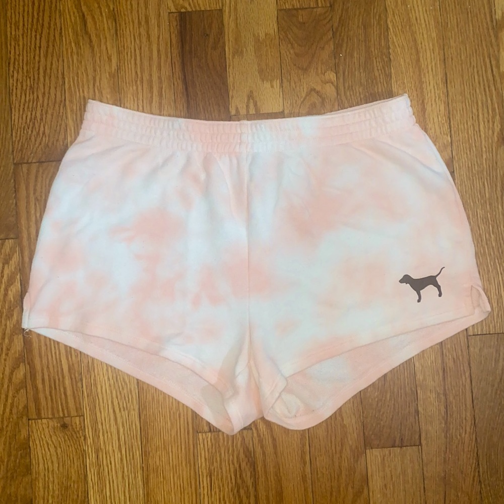 PINK tie dye shorts with classic logo at bottom right corner